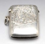 An Edwardian silver vesta case of oblong form and part foliate and floral engraving