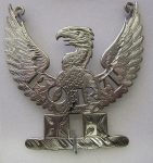 Bottle ticket with the word "PORT" (pierced lettering). Silver, pierced and engraved, upon a wreath a demi-eagle with wings displayed upon two crosses patty