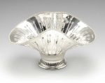 An early twentieth century silver bowl, of shaped circular form with serpentine sides, beaded rim and pierced gallery, raised upon a circular pierced footed base. Hallmarked Joseph Rodgers & Sons