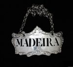 Bottle ticket with the word MADEIRA. Silver, shaped oblong with scrolled edges and chain attached.