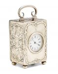 An Edwardian repousse silver repeating carriage clock The case by William Comyns, London, 1901