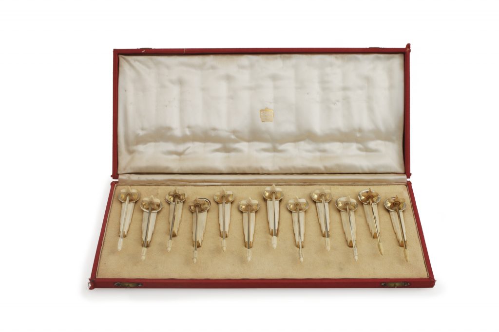 A Set of Twelve Art Deco Silver-gilt and Ivory Swizzle Sticks and Stands, Cartier, New York, circa 1935