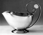 Sauce boat; silver, hand-raised, with high scroll handle enclosing a disc