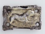 Rectangular horse harness plaque with figure of lion, bounding right; abraded. Gilt Silver with bronze back-plate.