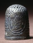 Thimble; silver; horizontal rows of dots, ornamented with two ovals, one containing crowned head and legend