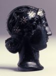 Bronze head inlaid with silver.