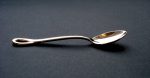 Silver 'Padova' teaspoon with handle curved at the end to form an open oval