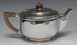 An Art Deco silver teapot, hinged cover, Bakelite geometric handle