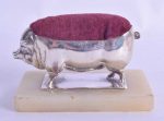 AN UNUSUALLY LARGE EDWARDIAN SILVER PIN CUSHION in the form of a pig